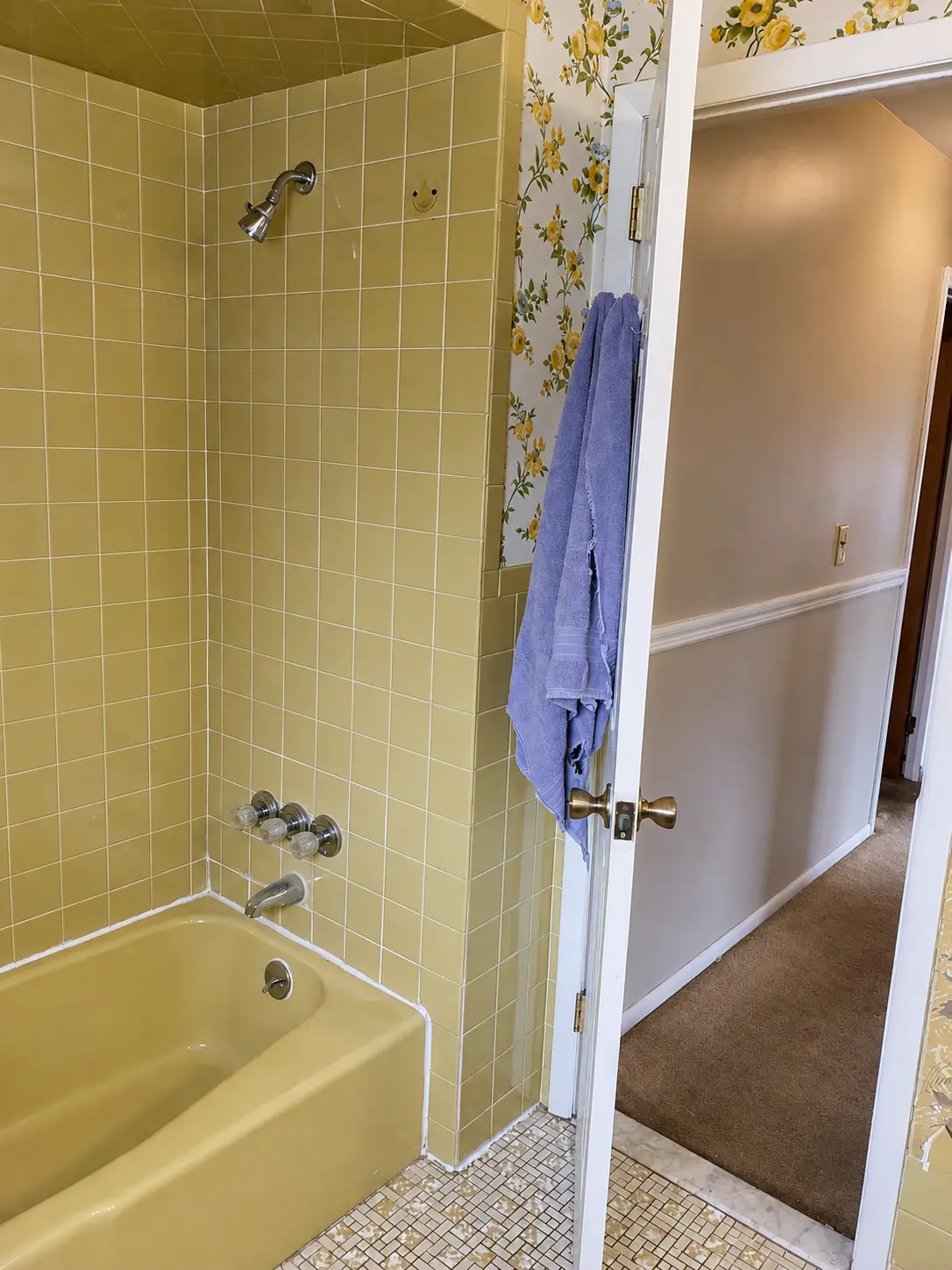 Original yellow tiled tub and shower surround before bathroom renovation